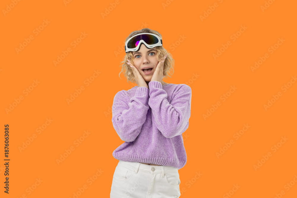 Fototapeta premium Blonde woman in ski goggles and a purple sweater