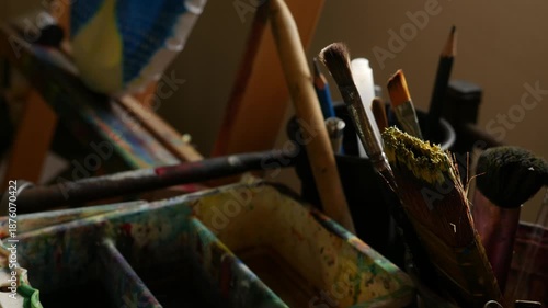 Artist Studio Workspace with Easel Paint Palette and Various Brushes