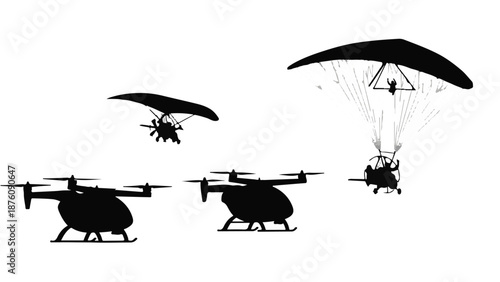 Silhouettes of helicopters and paraglider in flight