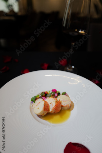 Elegant culinary presentation of delectable gourmet food. The dish is presented on a pristine white plate and features elements that evoke fine dining