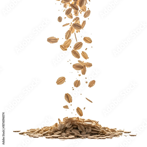 Dry rolled oat flakes cascading down into a small pile.