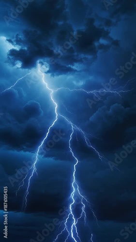 A bright blue lightning bolt strikes through a dark and ominous stormy night sky with heavy clouds