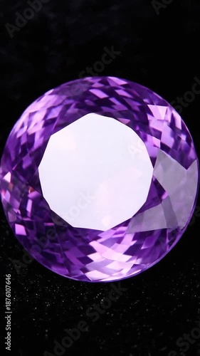 Large purple gemstone sparkling on black background, close-up, for luxury advertising