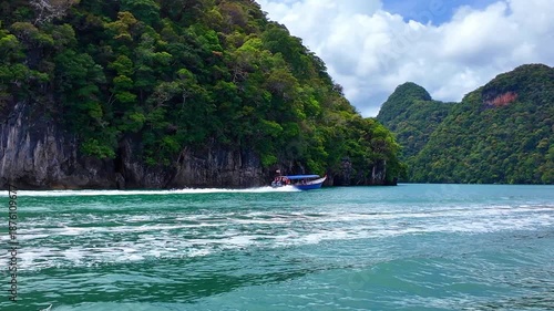 High-speed boats racing across turquoise waters near Pulau Dayang Island, Langkawi. White wakes trail behind as vessels cut through the sea, capturing energy, motion, and tropical island adventure.