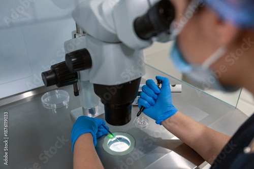 Schilderij op canvas Professional embryologist using microscope for ICSI IVF procedure, microinjection of sperm into female egg cell in fertility clinic laboratory for assisted reproduction, human artificial insemination