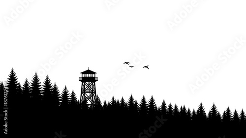 Silhouette of a fire lookout tower on a hill with pine trees.