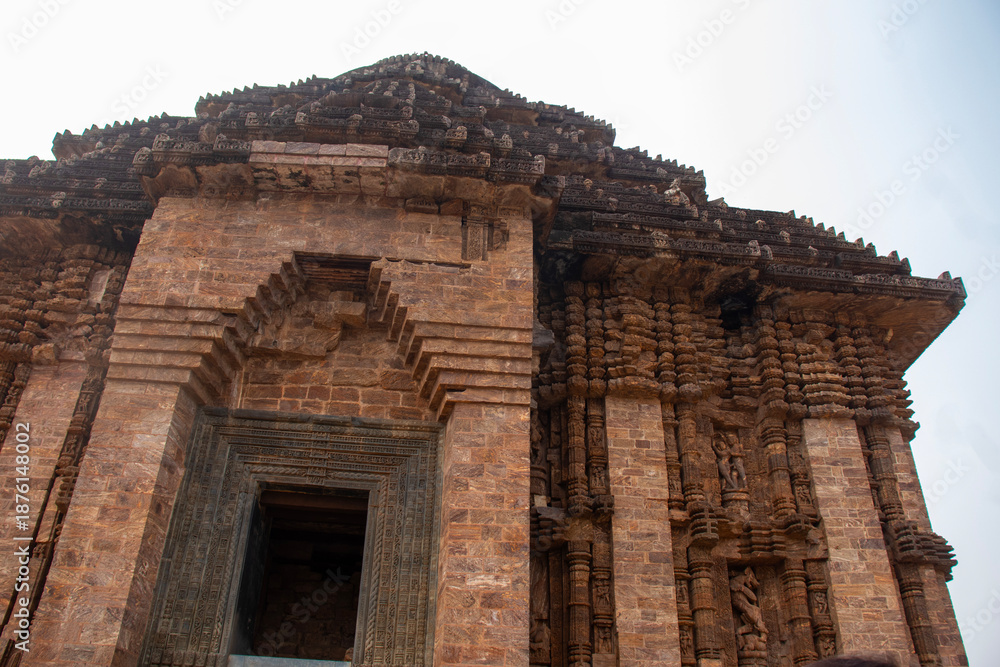 Fototapeta premium Intricately carved sandstone walls of Konark Sun Temple rise majestically, showcasing Kalinga architecture, mythological sculptures, and ancient Odisha craftsmanship heritage. 