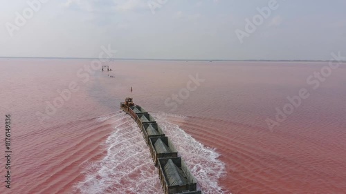 Burlinskoye Lake (Bursol), Altai Krai — Pink Salt Lake. A train‑like vehicle moves along the shore.