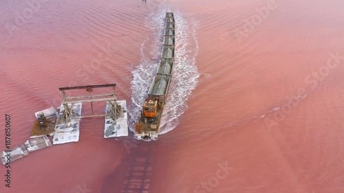 Burlinskoye Lake (Bursol), Altai Krai — Pink Salt Lake. A train‑like vehicle moves along the shore.