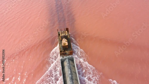 Burlinskoye Lake (Bursol), Altai Krai — Pink Salt Lake. A train‑like vehicle moves along the shore.