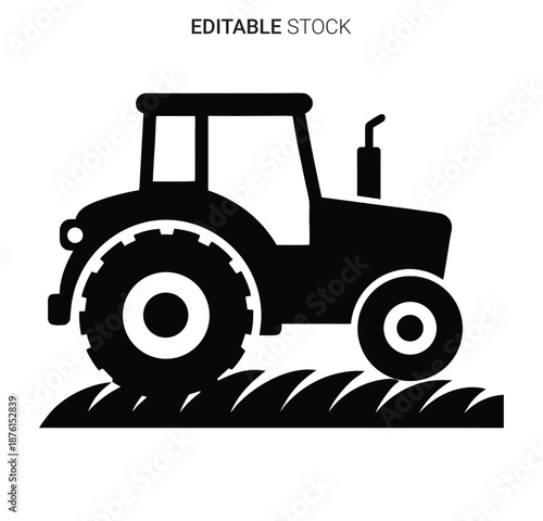 a black silhouette of a tractor on a plowed field silhouette high quality