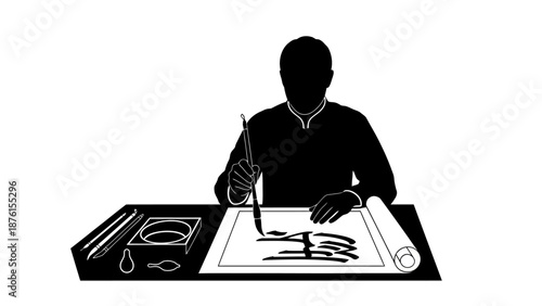 Artist designing on a large sheet of paper at a desk