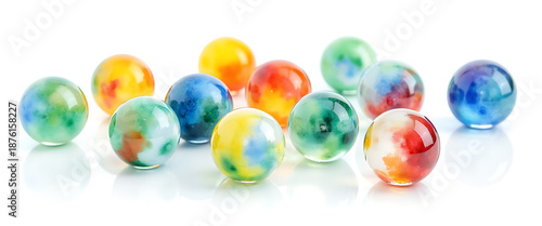Collection of swirling multicolored opaque glass marbles arranged in row on white reflective surface still life photograph