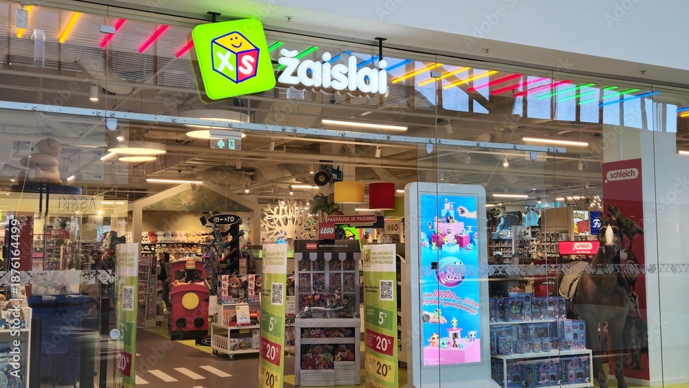 Fototapeta premium Vilnius Lithuania - 03.29.2025 Brightly lit toy store with colorful signage and wide selection of toys, including LEGO, plush animals, and action figures, creating a fun and welcoming atmosphere