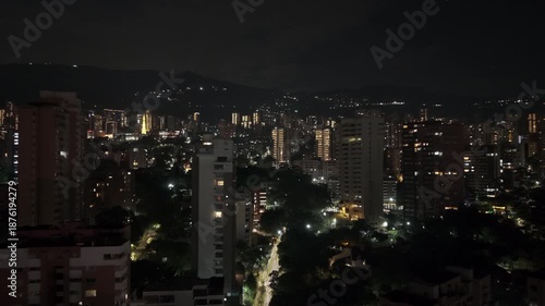 Wallpaper Mural Drone video capturing the illuminated skyline of Medellín at night, showcasing vibrant city lights and urban architecture under a clear, starry sky. Perfect for cityscape and night life themes. Torontodigital.ca