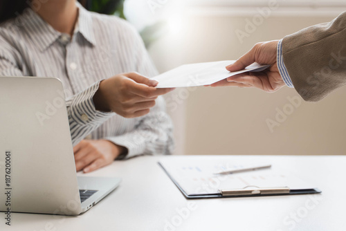 female employee smiling when she receive salary from boss.