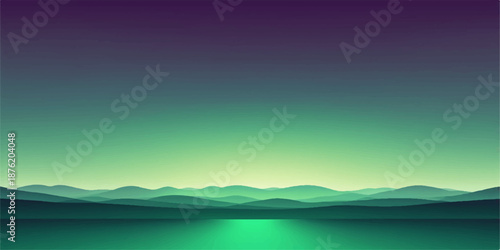 Beautiful mountain landscape with a calm lake under a colorful sunrise sky featuring soft clouds and morning fog over the distant hills