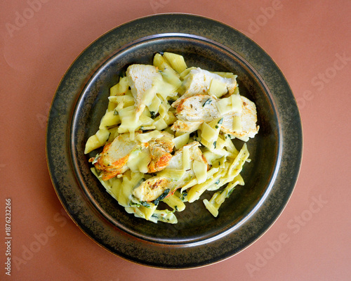 Creamy chicken and spinach pasta with thinly sliced Parmesan cheese. 