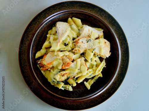 Creamy chicken and spinach pasta with thinly sliced Parmesan cheese. 