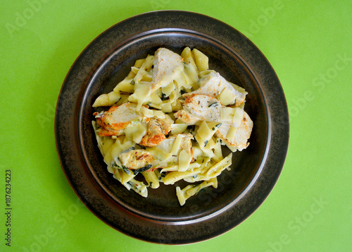 Creamy chicken and spinach pasta with thinly sliced Parmesan cheese. 