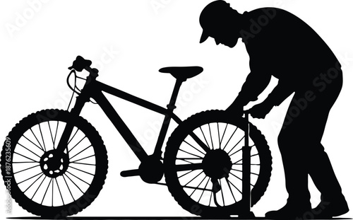 A man is fixing a bicycle tire silhouette