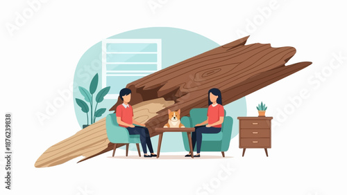 Two people and a dog sit in armchairs with a large fallen tree