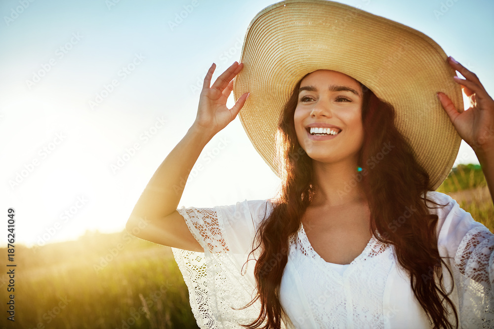 Fototapeta premium Thinking, woman and smile for travel in nature with reflection, fresh air and straw hat on holiday. Space, female person and vacation with vision in field, outdoor view and sightseeing in countryside