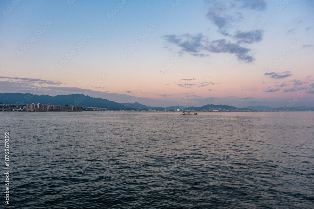 Obraz premium 夕暮れの宮島から眺める廿日市の市街地