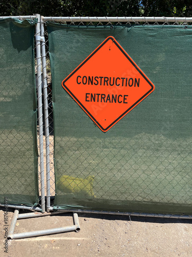 CONSTRUCTION ENTRANCE sign on a temporary fence