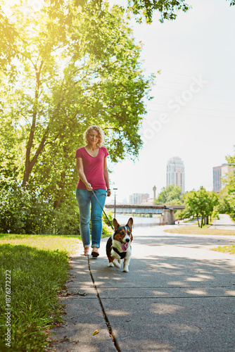 Fotografija Woman, outdoor and walk in park with dog, exercise and companion for bonding together on weekend