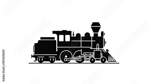 Vintage steam locomotive train engine with snowplow attachment in motion on tracks