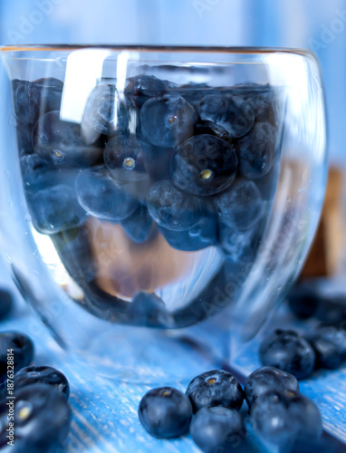 Blueberries lying on the table. Blue wooden background. Food