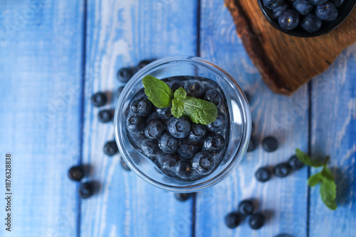 Blueberries lying on the table. Blue wooden background. Food