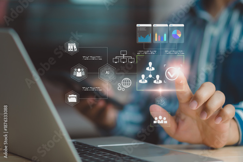 Business professional using AI interface on laptop for data management, user verification, workflow automation, digital analytics, and secure business decision support in modern enterprise technology.
