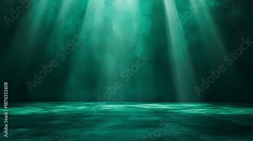 Deep emerald green backdrop with diffused lighting and, ideal for luxury decor or fashion accessories .