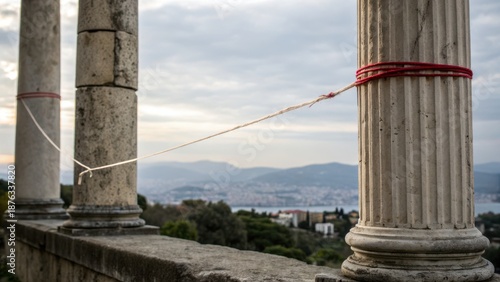 Emotional connection and architecture concept. Ruins with columns overlooking a scenic landscape and distant hills.