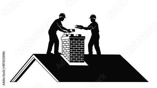 Two construction workers building brick chimney on roof with safety gear