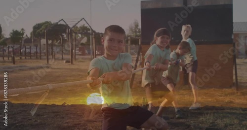 Playing tug-of-war, children enjoying outdoors with sunset animation in background