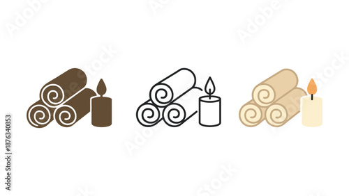 A serene spa setup with rolled towels and lit candles