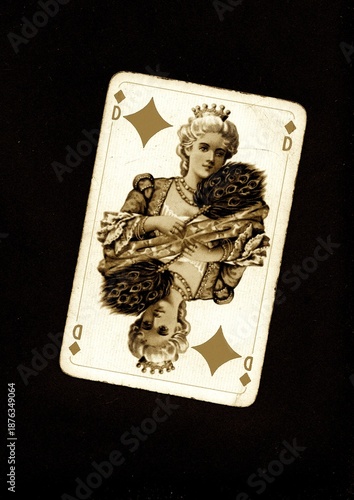 A vintage queen of diamonds playing card in sepia isolated on a black background.