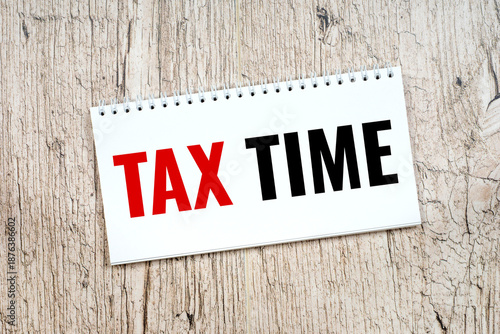 tax time reminder, office or home work place, top view notepad on wooden table