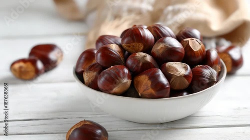 A bowl of chestnuts on wooden table