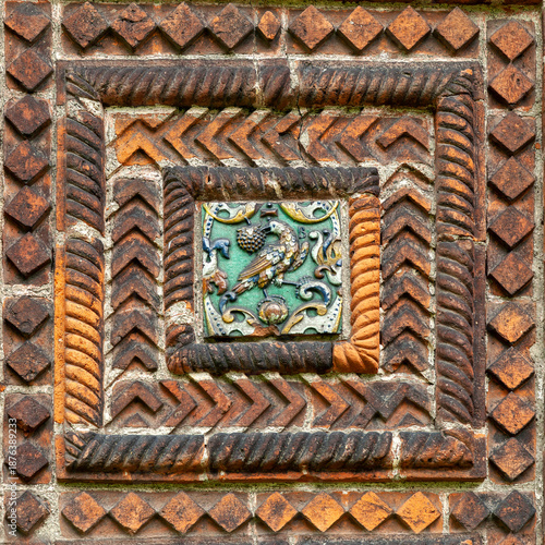 Old decorative brick tile with bird relief detail