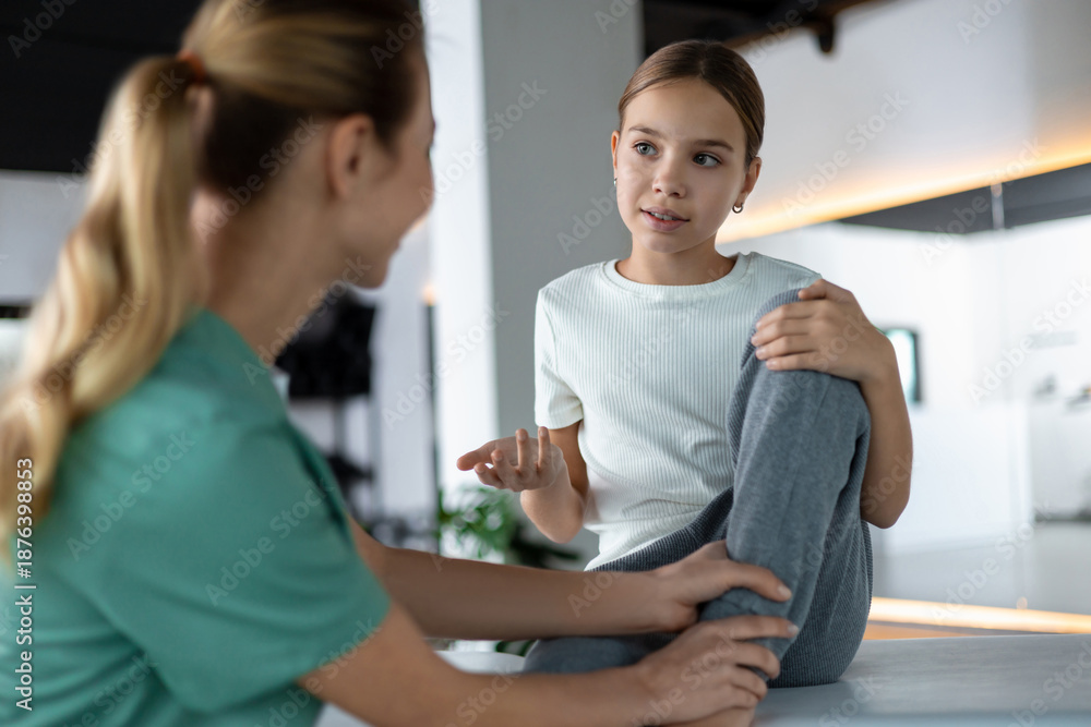 Fototapeta premium Therapist assisting patient during leg stretching and recovery practice