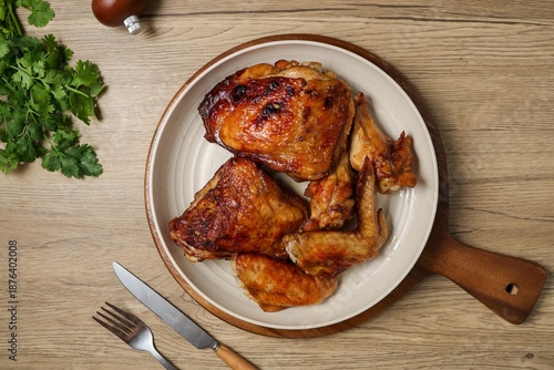 ​Delicious roasted chicken pieces served on a white plate.