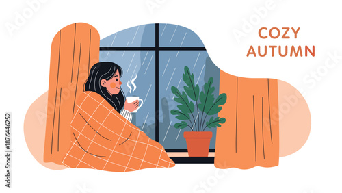 Cozy autumn scene of a young girl wrapped in a checkered blanket looking out of a rainy window while holding a warm cup of coffee.