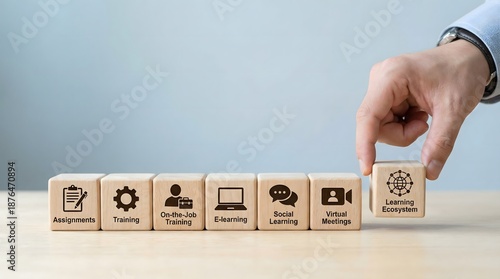 hand placing wooden block with learning objectives on table