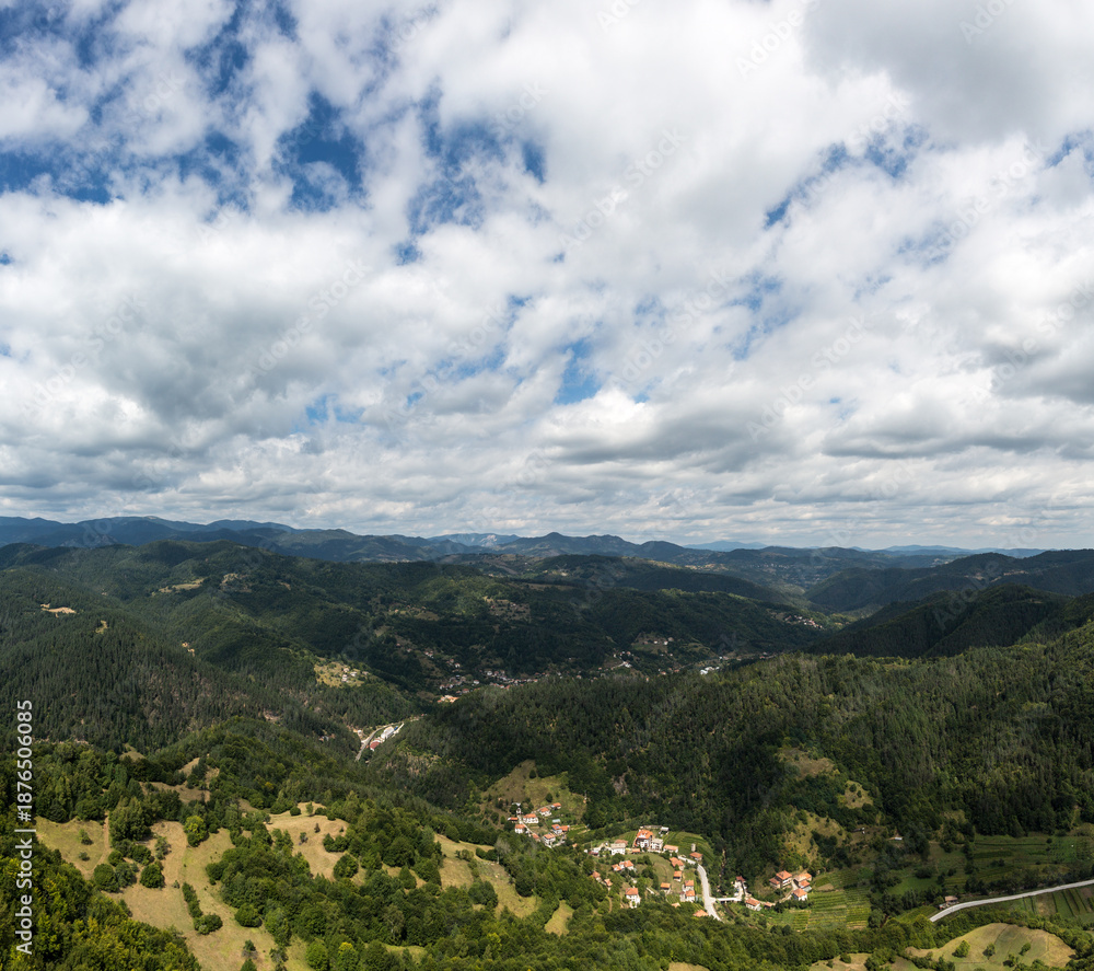 Fototapeta premium Mountain and forest with dramatic cloudy sky