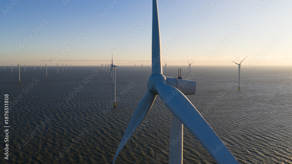 Φωτογραφία Aerial view of the colossal wind turbines stand in stark contrast to the rippling waters of the North Sea, Breezanddijk, Friesland, Netherlands