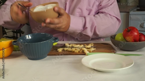 A man prepares fruit ice cream for dessert.